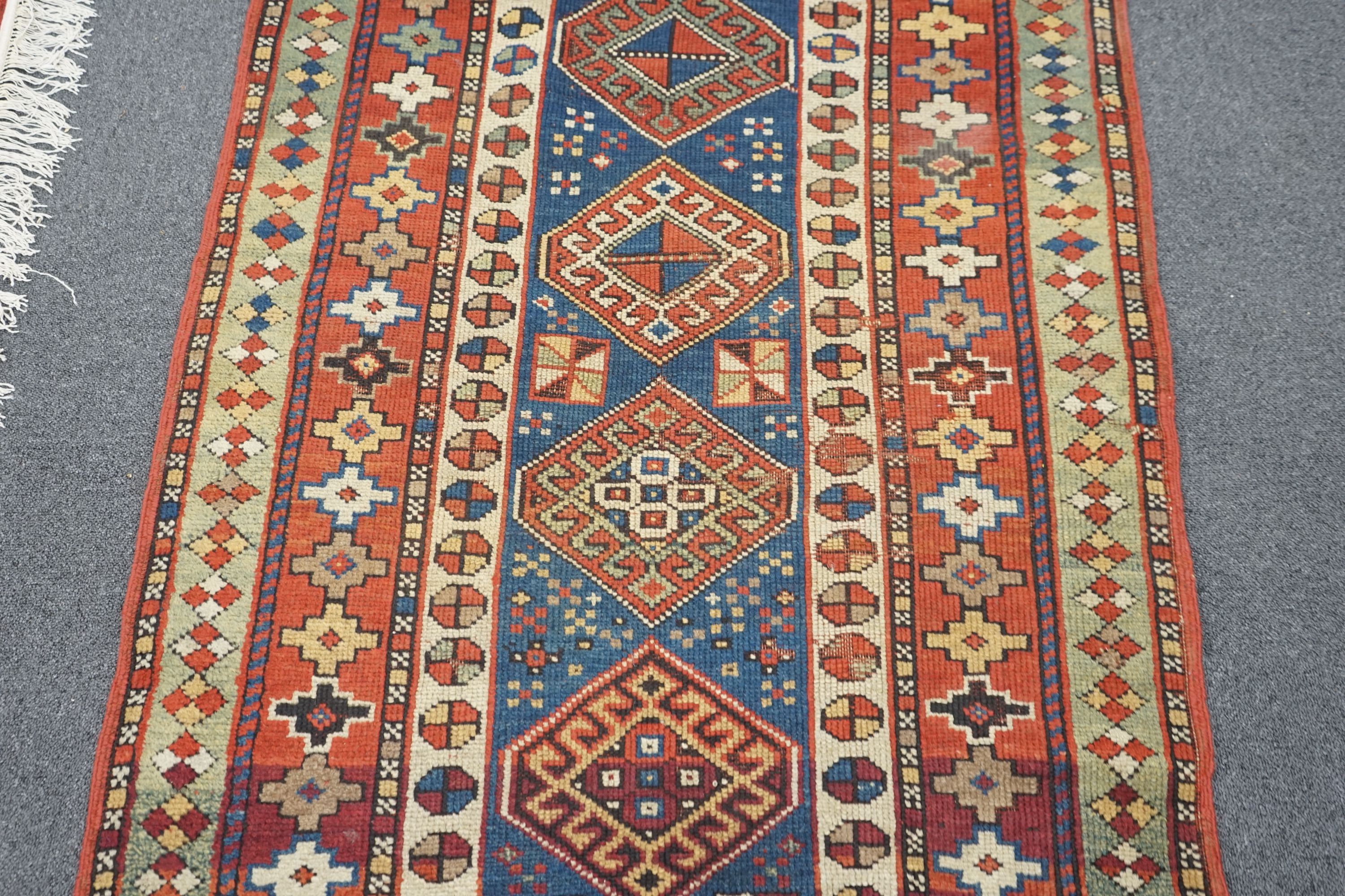 A Kazak blue ground rug, 152 x 95cm